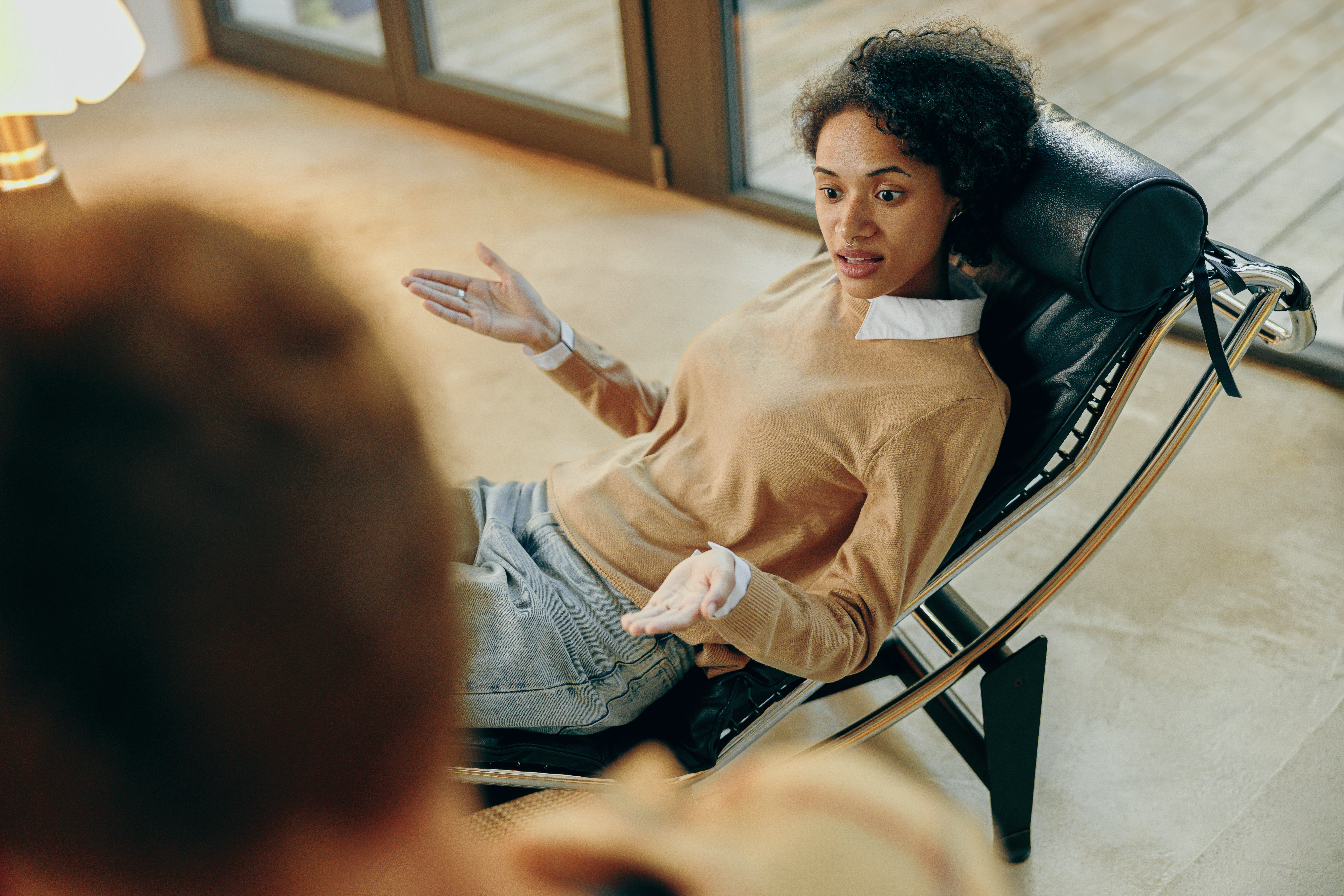A patient talks about her problems while lying on couch at psychologist appointment