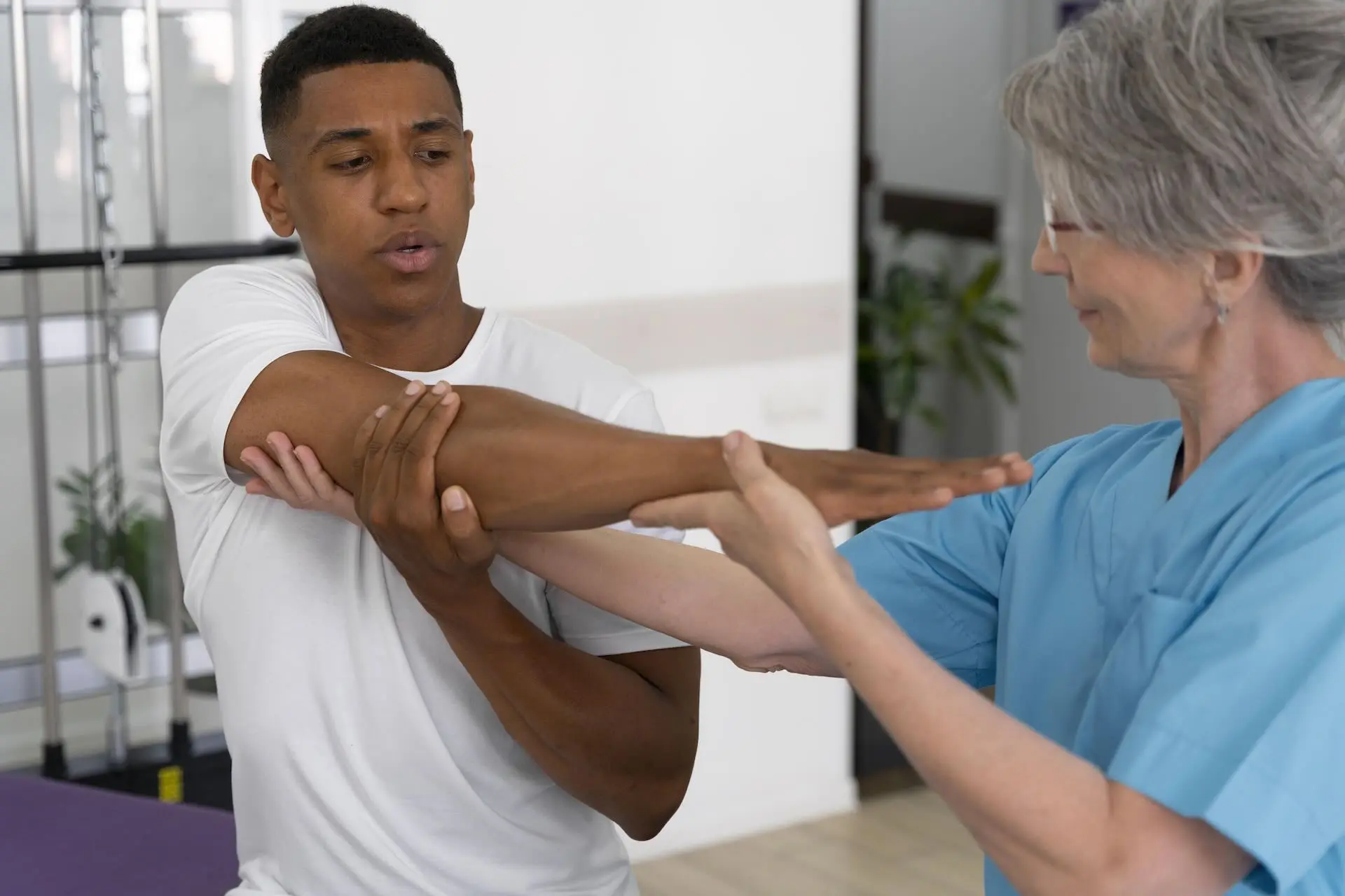 medical-assistant-helping-patient-with-physiotherapy-exercises-copy